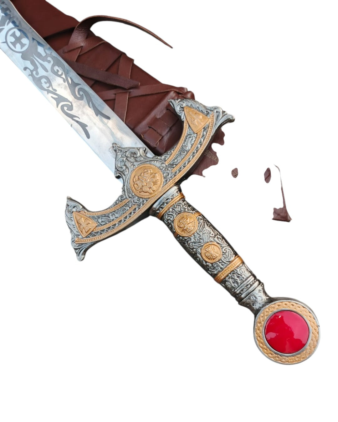 Decorative sword with ornate handle and red gemstone on a white background
