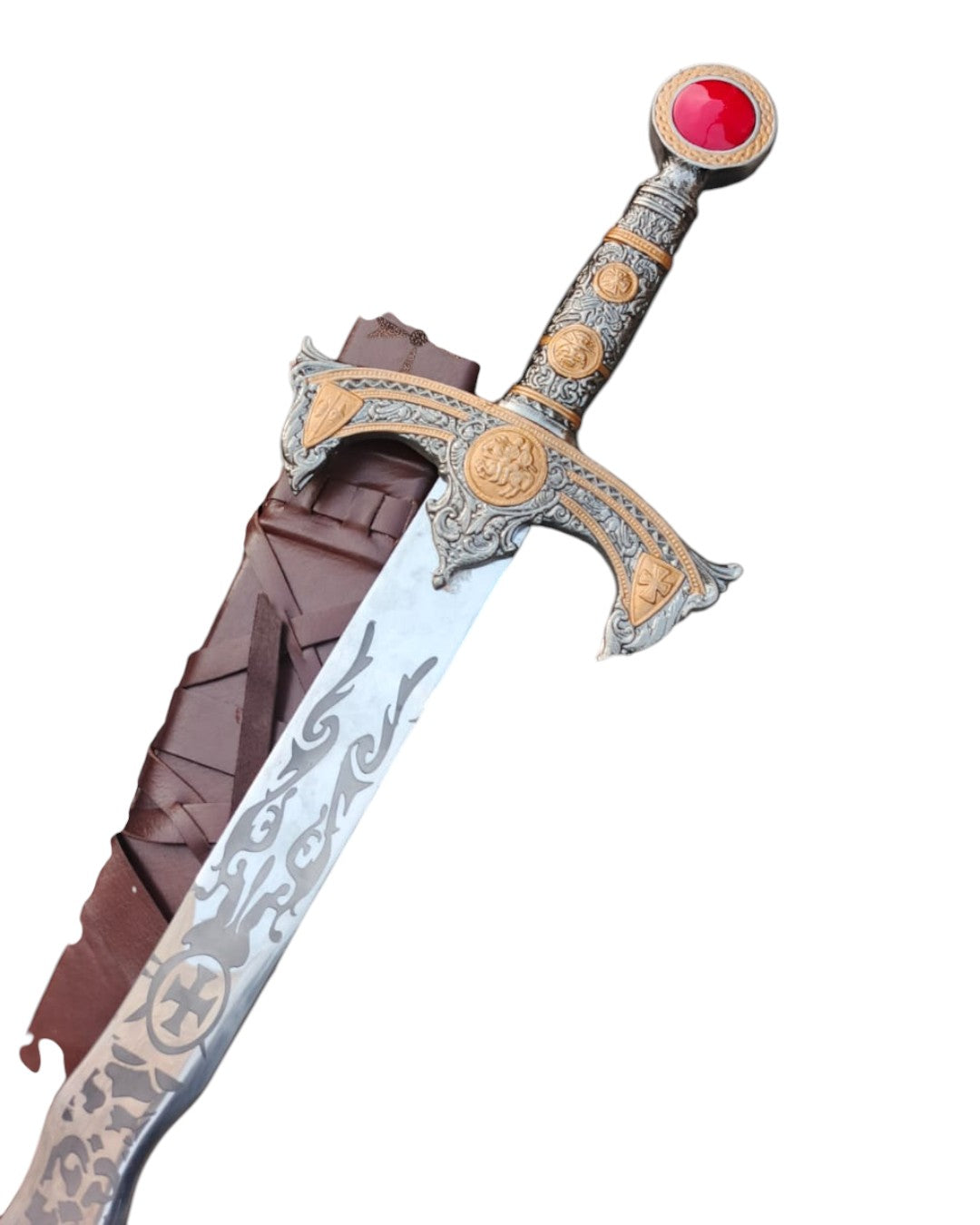Decorative sword with ornate handle and red gemstone on a white background